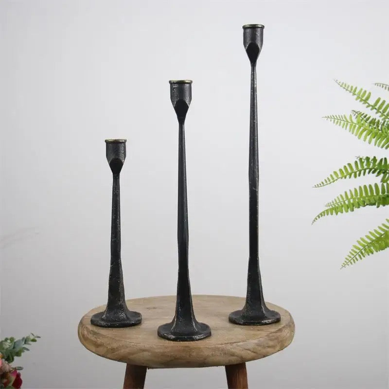 Set of 3 black iron taper candle holders on wooden table”
	•	“Modern rustic candle holders in small, medium, tall sizes”
	•	“Sculptural metal candlesticks for home decor”
